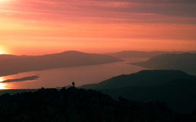 People who made it to the top of the mountain in sunset light
