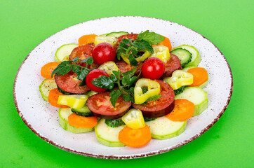 Healthy food concept. pPlate with chopped fresh vegetables on bright background. Studio Photo