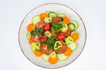 Plate with vegetables isolated on white background. Vegetarian food. Studio Photo