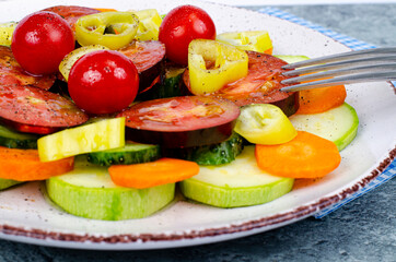 Vegetable slicing of seasonal vegetables on plate on gray-blue background. Studio Photo.