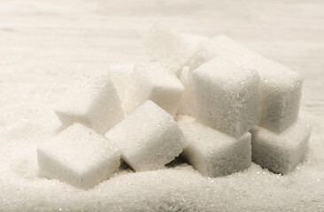 Sugar cubes close-up on a wooden background. Sugar