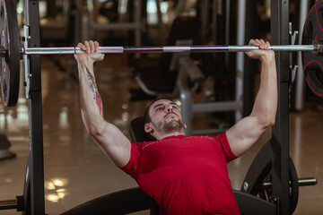 young man exercising with barbells and weights
