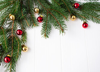 Obraz na płótnie Canvas christmas composition: frame of fir branches and balls