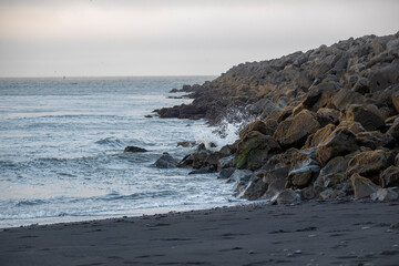 Seascape of waves crashing on Black Sand Beach in Vik Iceland