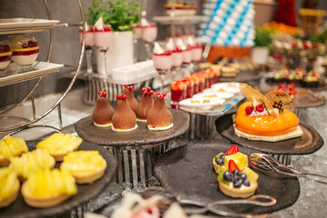 Assortment of confectionery, different types of cakes and desserts on the table.