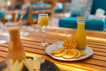 Glasses with fresh organic fruit juices on the table