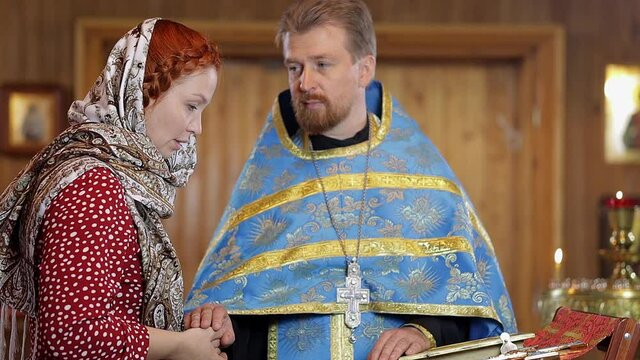a woman repents of her sins, confessions with a priest in an Orthodox church, selective focus