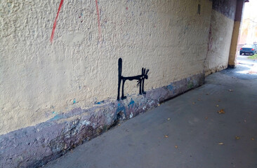 A black cat painted on a brick wall in a doorway