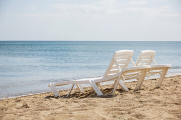 Sun loungers by the sea. For the screensaver. Summer background. Rest at the sea. Vacation. For two