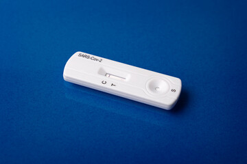 Close up image of Rapid test device for Covid-19 showing negative result. Lab card kit test for coronavirus SARS-CoV-2 virus. Fast test COVID-19 on purple surface