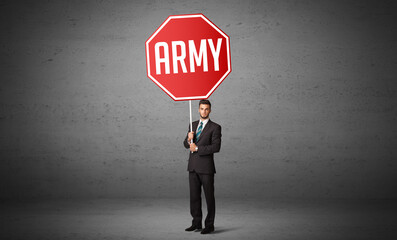 Young business person holding road sign