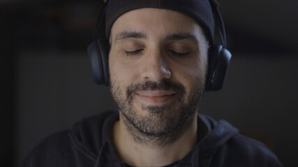 Man listening to music with closed eyes. Concept of mindfulness, relaxation or meditation