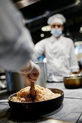 Indian chef preparing rice with spices