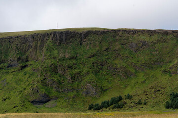 Cloudy landscape of meadow and cliffs in Vik South Iceland