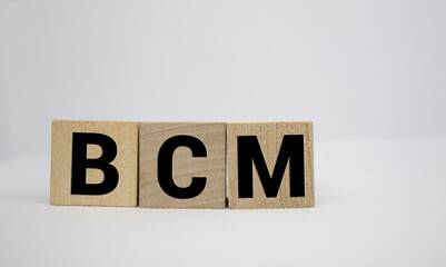 BCM, plan do study act symbol. Businessman hand. Wooden cubes and blocks with words 'PDSA, plan do study act'.