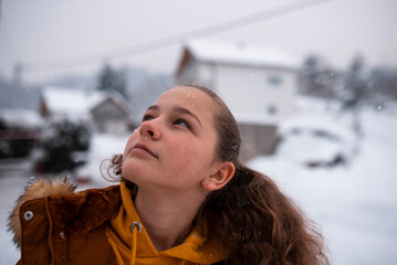 Portrait of a happy teenage girl in the snow
 - obrazy, fototapety, plakaty