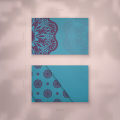 Turquoise business card template with Indian purple pattern for your contacts.