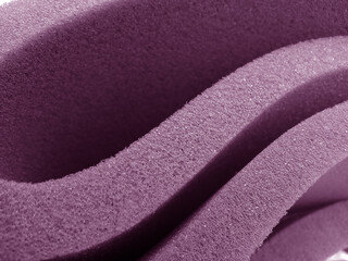 Fototapeta na wymiar rough texture of light purple sponge foam. edge cut from sheet material