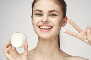 woman with jar of cream makeup face skin care close-up