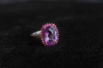Amethyst ring looks elegant on a black background.
