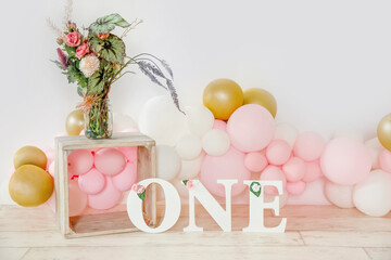 1st birthday studio setups, decorations with balloons and flowers, one year party, copy space. 