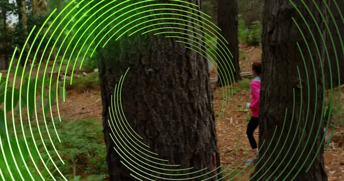 Animation of green line spiral rotating over woman and man running in forest