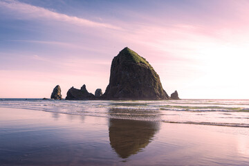 haystack rock in cannon beach reflecting in the waves  - Powered by Adobe