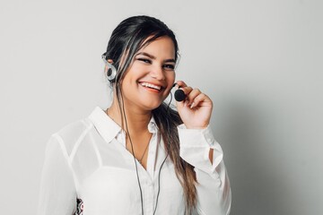 Call center agent with headset working on support hotline in modern office with copy space.