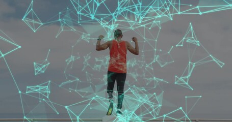 Animation of network of connections over male athlete with running blade raising arms outdoors - Powered by Adobe