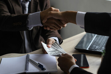 Businessman giving money to bribe the employee