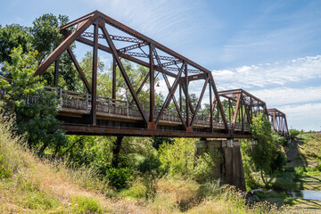 Old iron rusty bridge over a Putah Creek in Winters CA.