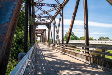 Old iron rusty bridge over a Putah Creek in Winters CA.