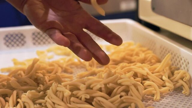 Casarecce falling, pasta machine, pasta maker, machine, basket, restaurant. 4K 24FPS.