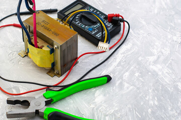 electric transformer pliers and ampervoltmeter on the table surface