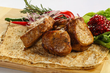Pork tenderlion kebab over board