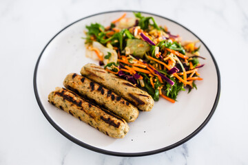 vegan sausages with fresh side salad, healthy plant-based food
