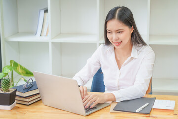 A woman using computer for working in a office