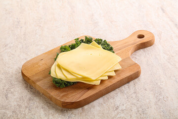 Sliced Gouda cheese over board