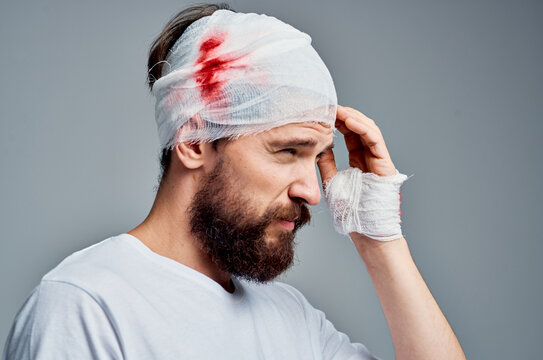 Man bandaged head and hand blood isolated background