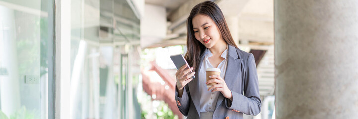 Working woman concept a young female manager attending video conference and holding a cup of coffee