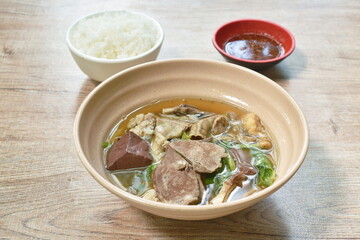 boiled pork blood and entrails with chop pork in soup on bowl dipping chili sauce eat couple plain rice