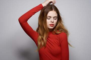 beautiful woman fashion hairstyle red sweater model light background