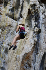 Thai people climber and foreign mountaineer travelers sport rock climbing at Dragon Crest Precipice Mountain and Railay Stone cliffs and travel visit rest relax in Ao Nang beach bay in Krabi, Thailand