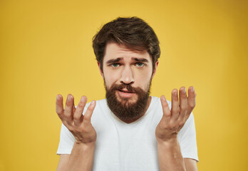 Man in a white t-shirt irritated facial expression close-up