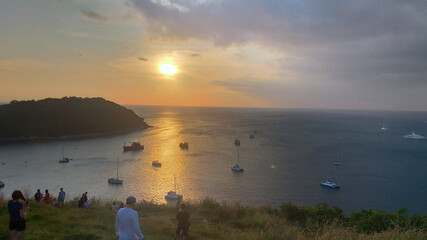 people watching the sunset in the evening on vacation