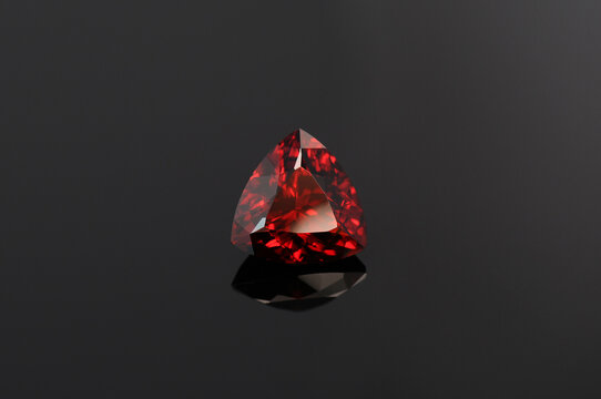 Natural mined pyrope garnet red colour gemstone. Unheated, untreated. Triangle shaped, trillion or trilliant faceted,transparent colorful flawless semiprecious gem setting for jewelry making. Gemology