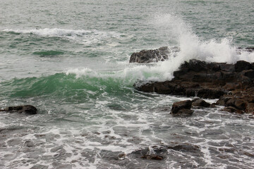 岩に当たって砕ける波