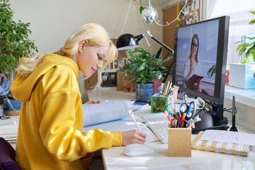 Teenage student having an online lesson on the computer at home