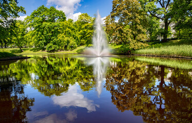 Panorama of the beautiful Riga canal with fountain in Bastion park on summer day in Riga, capital...