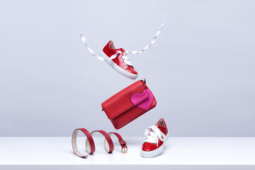 Women's shoes and accessories flying in the air on a light background. Fashionable women's items....